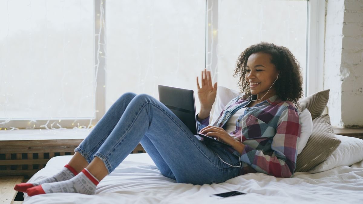 Woman starting a telehealth therapy session on her laptop at home in Colorado
